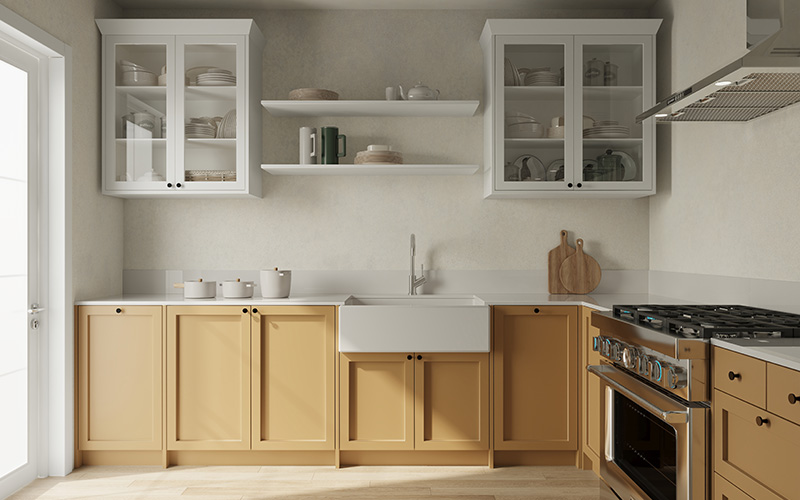 A modern farmhouse kitchen with tan lower cabinets, white upper cabinets, a white apron-front sink, and a stainless steel stove.